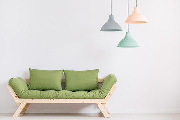 Wooden sofa with green pillows