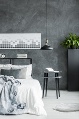 Monochromatic bedroom with concrete wall