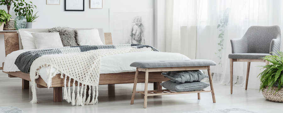 Wooden bed in simple bedroom