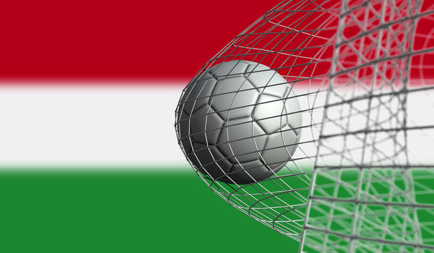 Soccer ball scores a goal in a net against Hungary flag. 3D Rendering