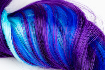 Curly voluminous shiny purple color hair on a white background