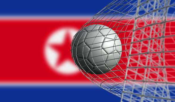 Soccer ball scores a goal in a net against North Korea flag. 3D Rendering