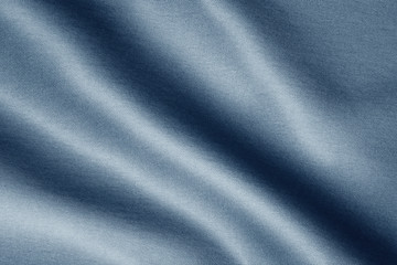 texture of dark blue fabric with large diagonal folds, abstract background
