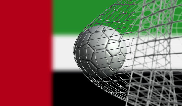 Soccer ball scores a goal in a net against UAE flag. 3D Rendering