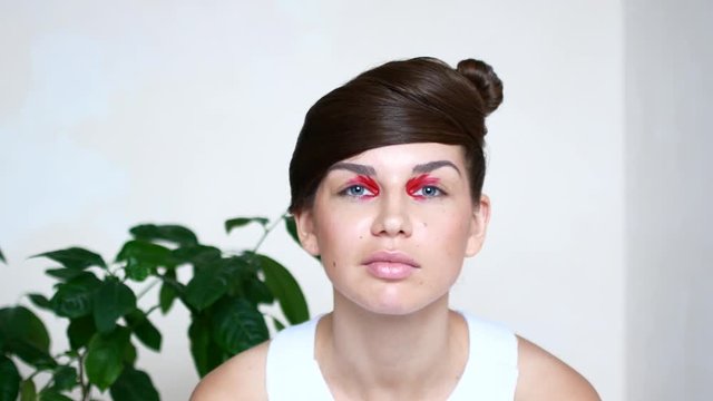 Emotional portraits of a beautiful young woman with bright red make-up