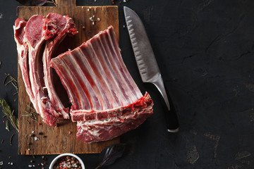 Raw cutted rack of lamb on wooden board