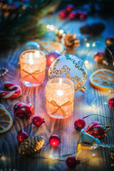 A Couple of Magic Christmas decorated Burning candles on wooden rustic background 1