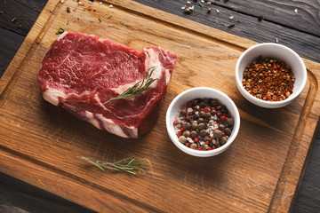 Raw beef filet mignon steaks on wooden board