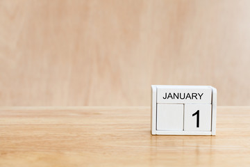 Wooden cubes with the numbers 1 January on wooden table. Merry christmas and Happy new year season with greeting card, illustration. copy space
