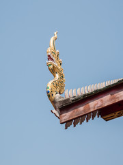 Fototapeta na wymiar Wooden dragon head on the eaves of the church.