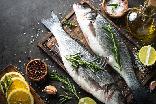 Fresh fish seabass on black.