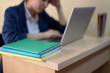 Experienced Asian journalist typing press release for online issue using laptop computer and wireless connection to internet