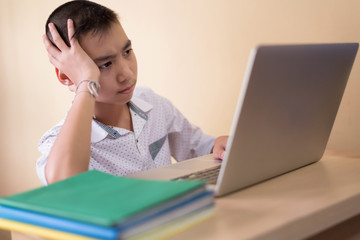 Young boy student, studying computer and is happy to learn new things new