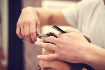 Obraz na płótnie Canvas Barber at work. Hairdresser cutting hair of client