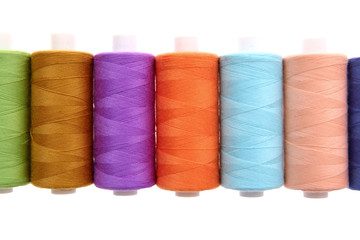 A colorful spool with threads often used in tailoring and is an indispensable element of this profession.
