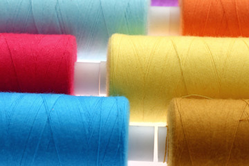 A colorful spool with threads often used in tailoring and is an indispensable element of this profession.
