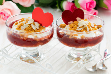 portioned dessert with berry jam and cream for Valentine's Day, close-up