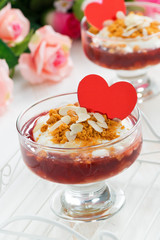 portioned dessert with berry jam and cream for Valentine's Day, vertical