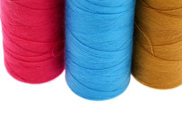 A colorful spool with threads often used in tailoring and is an indispensable element of this profession.
