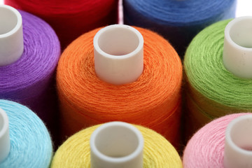 A colorful spool with threads often used in tailoring and is an indispensable element of this profession.
