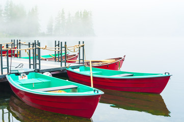 Fototapeta na wymiar Boats in lake Strbske Pleso in High Tatras National Park, Slovakia