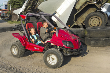Fototapeta na wymiar Father and daughter quad ride. Concept of friendly family.
