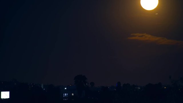 Full moon rising above city of Los Angeles horizon at night. 4K UHD Timelapse