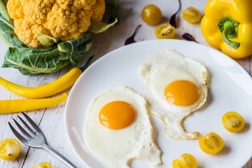 Fried eggs with vegetables. Beatiful breakfast in the morning.