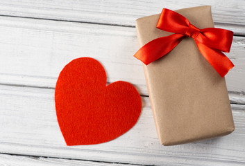 red heart and gift on wooden background