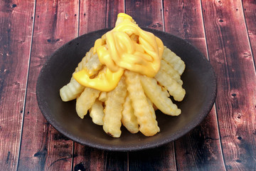 Volcano French fries as French fries topped with cheese arranged is like the volcano .