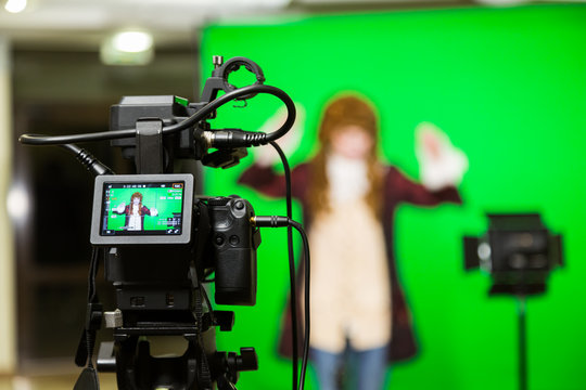 The actor starred in the interior on a green background. The chroma key. Filming equipment.