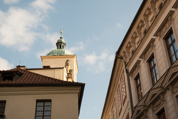 Looking up at the Basilica of Saint James (Kostel svateho Jakuba Vetsiho) in Prague, Czech Republic. Green dome and statues on the facade of the Church of St James in Prague.