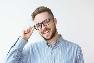 Fototapeta na wymiar Portrait of Smiling Young Man Wearing Glasses