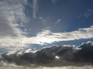 Naklejka na ściany i meble Sky with giants cumulonimbus clouds and sun rays through