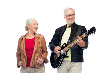 happy senior couple with electric guitar
