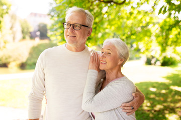 Fototapeta premium happy senior couple hugging at summer park