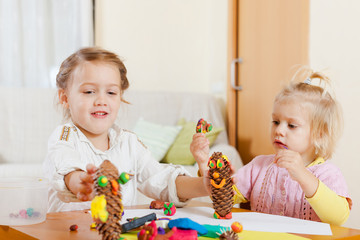 Preschoolers molding figurines from plasticine .