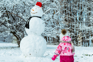 little kid run to snowman