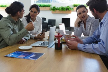 Group of executives discussing a project at desk