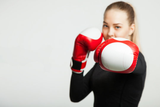 girl with the red boxing gloves, black background with copy space