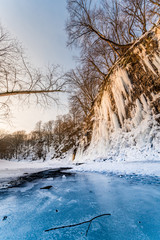 Sunrise at frozen river during winter blue and orange colors
