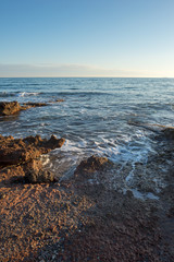 The calm sea in a very cloudy sunset