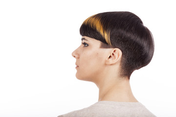 Profile of young woman wearing pixie short highlighted haircut, white background