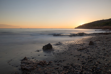Fototapeta premium The calm sea in a very cloudy sunset