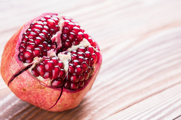 Big red pomegranate on the wooden board.  Ripe granet fruit.