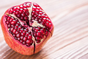 Big red pomegranate on the wooden board.  Ripe granet fruit.