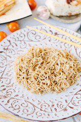 Chinese food: rice noodles on ceramic plate.
