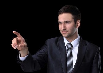 businessman pointing to a blank spot.isolated on a black background.