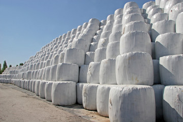 Packing bales with garbage, Wrapped stacked bales round with white plastic film,  Recycling and...
