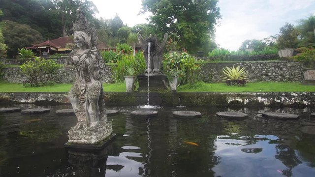 Cinemagraph - Hindu Balinese Water Palace Tirta Gangga with statues of the gods, fountains on Bali island, Indonesia. Motion Photo. Tirta Gangga the former royal water palace is a maze of pools and